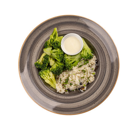 Vegetarian menu concept, broccoli and rice served with sauceの写真素材