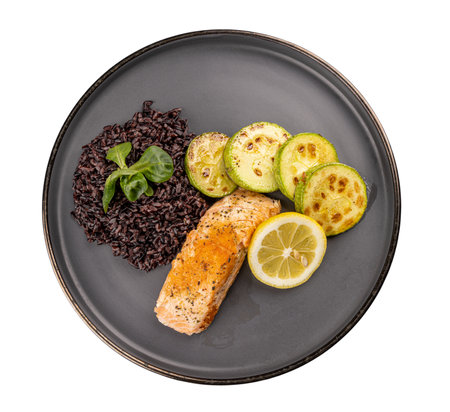 Roasted fish fillet served with wild rice and grilled zucchiniの写真素材