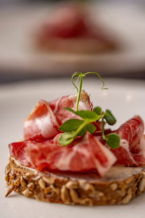 Smoked bacon slices on rye bread, sandwich with prosciuttoの写真素材