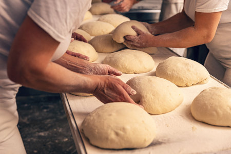 Bakers forming bread dough in a bakery. Bakery Concept.の写真素材