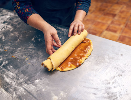 Rolling salted caramel filling dough for make babka. Bakery procedureの写真素材