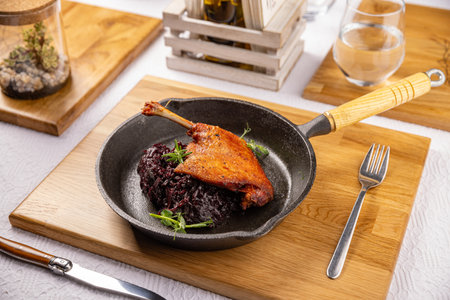 Portion of roast duck leg served with red cabbageの写真素材