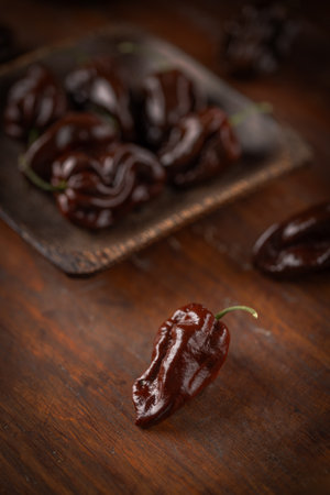 Chocolate habanero peppers on wooden surfaceの写真素材