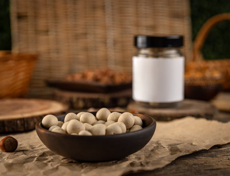 Crunchy white chocolate covered peanuts resting in a bowl on rustic wooden backgroundの写真素材