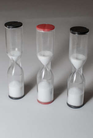 three running hourglasses in a line