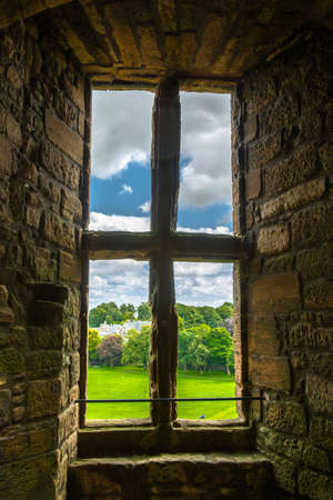 Old window with view to the garden Old window with view to the garden