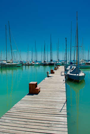 A long jetty of a harbor with numerous sail boats on Lake Balaton in Hungaryの写真素材
