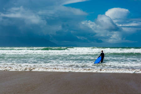 Surfer at Inch Beach in Ireland