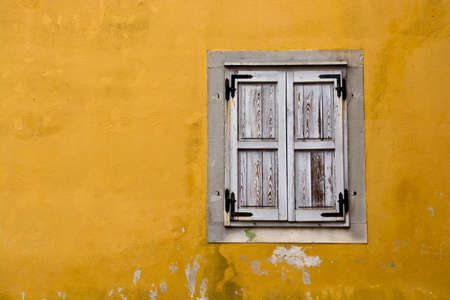 White Wooden Windows on Yellow Stone Wallの写真素材