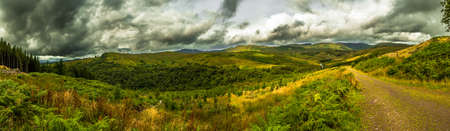 Scenic Landscape With Green Valley And Cloudy Sky In Scotlandの写真素材