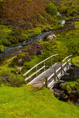 Small Wooden Bridge Over Wild Creek On The Isle Of Skye In Scotlandの写真素材