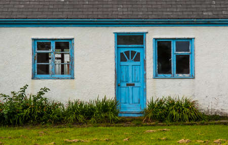 Old House With Blue Wooden Door And Windows In Ullapool In Scotlandの写真素材
