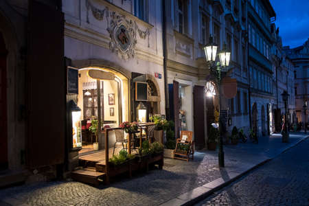 Picturesque Restaurant Illuminated By Streetlamp Lanterns In The Streets Of Prague In The Czech Republicのeditorial素材