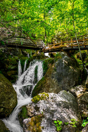 Hiking Trail With Wooden Bridge Over Waterfall Through Green Canyon At MyrafÃ¤lle In Austriaの写真素材