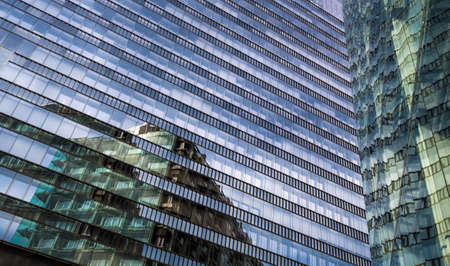 Glass Facade Of Modern Office Buildings With Reflections Of Neighboring Towers In The City Of Vienna