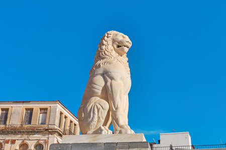 Sitting lion against the blue sky on Samos island in Greece. The island is located close to the Turkish coast and is very popular with tourists.のeditorial素材