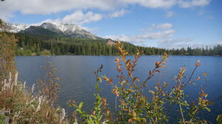 Strbske pleso and Tatra peaks visible from the back. A village located in the valley, from which...