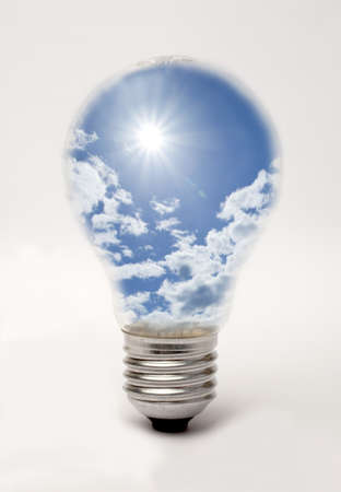Edison screw lightbulb containing sun and blue sky, suggesting solar energyの写真素材