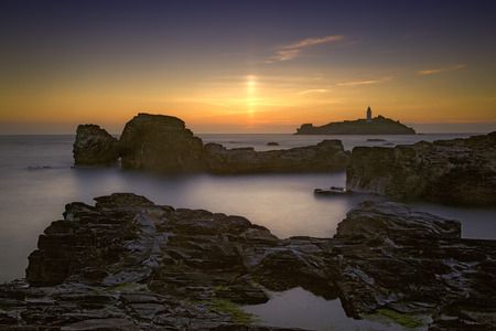 Sunset at Godrevy Head lighthouse, St Ives, Cornwallの写真素材