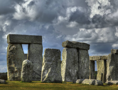 Close up of Stonehenge sunlit with dramatic cloudsの写真素材
