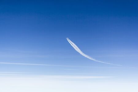 Jet aircraft in flight changing course, landscape formatの写真素材