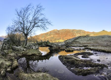 Slaters Bridge over the River Brathay in the Little Langdale Valley looking towards Lingmoor Fell, Lake Districtの写真素材