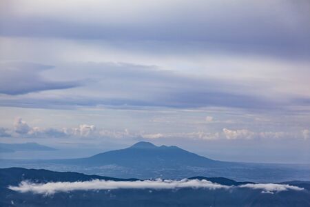 Aerial view of Mount Vesuvius with band of cloud in foreground