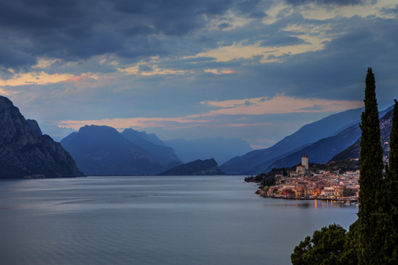 Malcesine on Lake Garda just after sunset with buildings litの写真素材