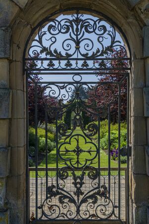wrought iron gate leading to formal garden at stately homeの写真素材