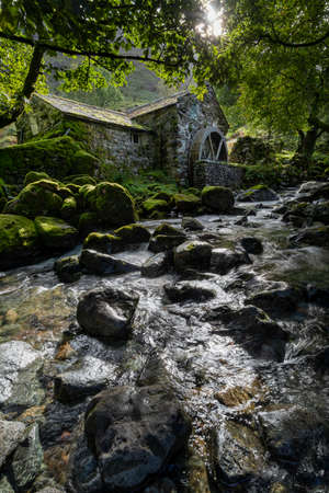 secluded water mill on combe gill in borrowdale lake district vertical formatの写真素材