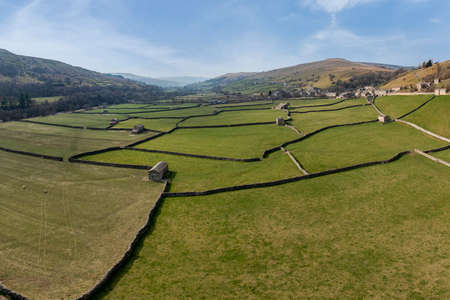 elevated view of patchwork fields and traditional stone barns at gunnerside in swaledale north yorkshireの写真素材