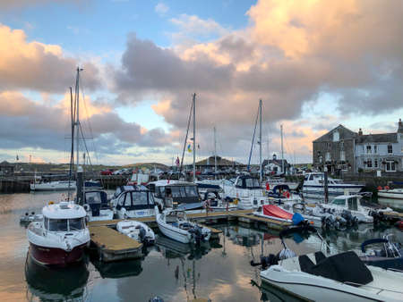 boats in padstow harbour cornwall at sunsetの写真素材