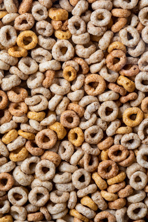closeup of breakfast cereal hoops in a clear plastic container with sugar granulesの写真素材