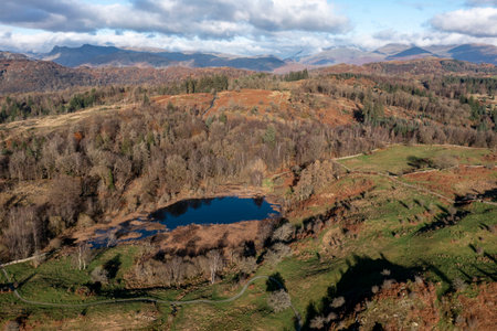 elevated view of wharton tarn and the langdale pikes beyond lake district winter sunの写真素材