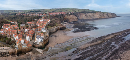robin hoods bay near whitby north yorkshire elevated panoramic view sunny day low tideの写真素材