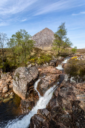 buachaille etive mor glencoe scotland with river coupall waterfall blue sky summerの写真素材