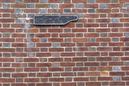 Old brick wall with blank direction signの写真素材