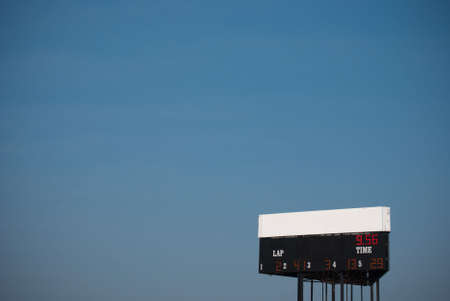 A black race billboard witha  blank white space in the bottom right corner of a big blue sky.の写真素材