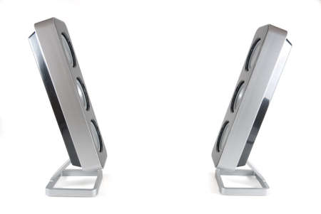Two black and silver modern speakers facing each other on a white isolated backgroundの写真素材