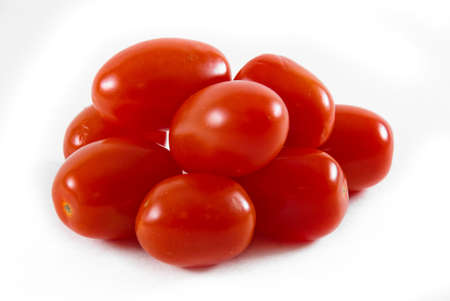 Several red cherry tomatoes over white background.の写真素材