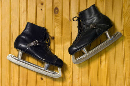 a pair of ice skates hanging on the wallの写真素材