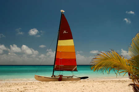 a catamaran on the beach waiting to be hiredの写真素材