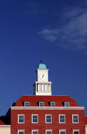 a clock tower on top of an office blockの写真素材