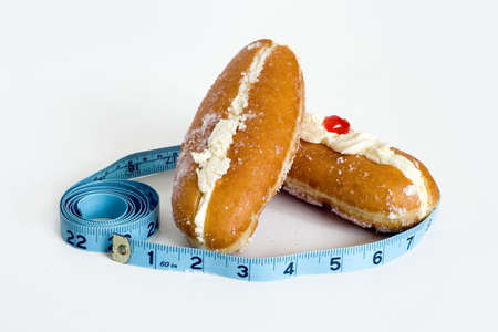 2 lovely cream doughnuts waiting to be eatenの写真素材