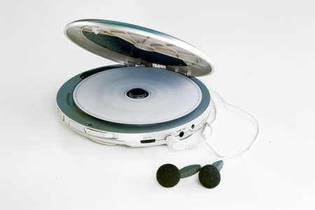 a personal cd player playing a music cd, on white backgroundの写真素材