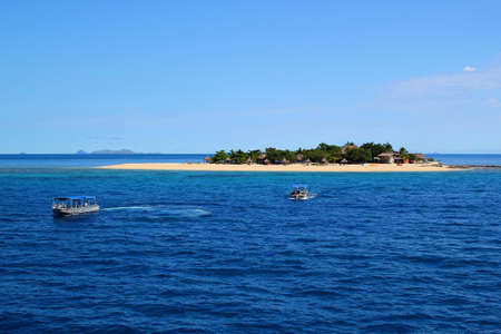 Small exotic tropical dream island in the middle of the pacific ocean / S Fijiの写真素材