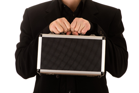 man strong keeps in a black before himself a metal caseの写真素材