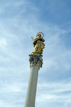 Statue of Holy mother Marry on city street with blue skyの写真素材