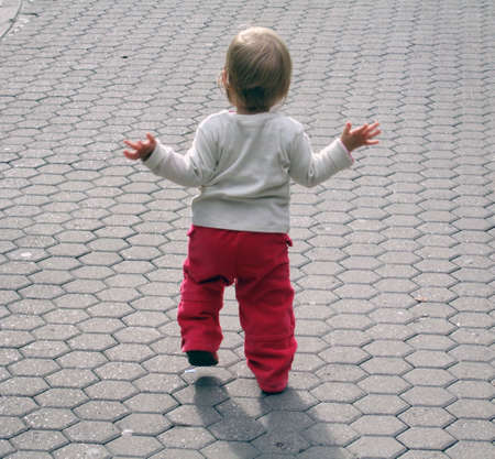  girl takes her first steps in lifeの写真素材