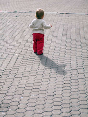 Small  girl takes her first steps in the life